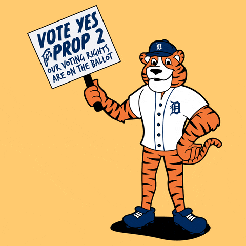 Illustrated gif. Paws the Tiger on a cantaloupe orange background waving a picket sign that reads "Vote yes for Prop 2, our voting rights are on the ballot."