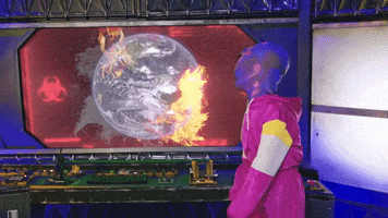 Video gif. Seeing a monitor showing a planet exploding with flames, a purple alien in a pink tracksuit stomps and flings its arms down, shaking its head in frustration or shame.