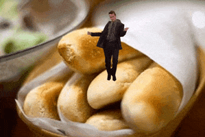 Photo gif. A video of Chandler from Friends dancing goofy on top of an image of a basket of breadsticks.