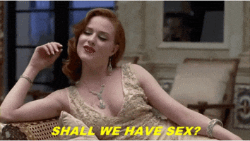 Reality TV gif. A woman from Bachelor in Paradise is wearing a 20s styled dress and laying sexily on her side. She asks, "Shall we have sex?"