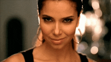 Celebrity gif. Roselyn Sánchez stares at us and gives us a wink.