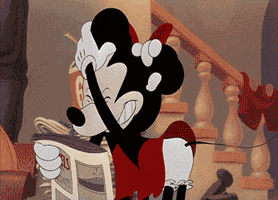 Disney gif. Minnie Mouse comes over to Mickey, who's reading a newspaper, and grabs his ears before pulling him in tightly for a smooch. She runs away giggling while Mickey looks dazed with lipstick on his lips.