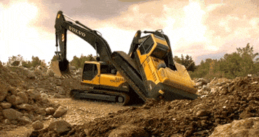Video gif. Looping video of a digger truck rolling up on top of another digger truck, appearing to hump the truck.