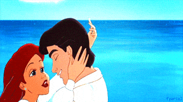 Disney gif. Ariel grasps Eric as she kisses him passionately in the Little Mermaid.