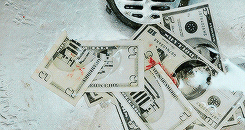 Movie gif. A scene from the Drop. A couple of cut up five and ten dollar bills lay on the bottom of a sink near the drain. Water flows over it and washes some of the blood that's on the bills. 
