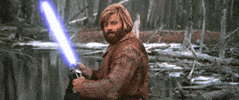 Movie gif. Robert Redford as Jeremiah Johnson, in the movie of the same name, holding a blue-white light saber and giving a subtle, approving nod.