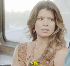 TV gif. Andrea Navedo as Xiomara in Jane the Virgin places a hand on her chest and darts a shocked gaze to the person beside her. Text, "Me!!"