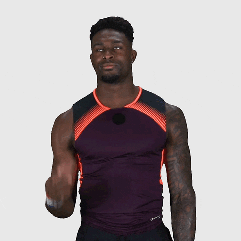 Sports gif. DK Metcalf points upward with one hand and nods.