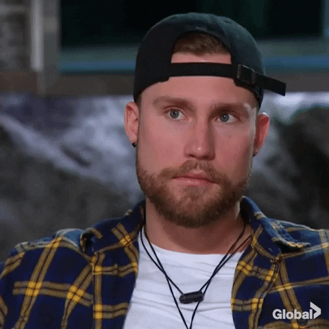 Reality TV gif. Contestant on Big Brother nods slowly as he listens with rapt attention.