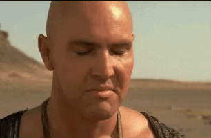 Movie gif. Subtle menacing smile creeps across the face of Arnold Vosloo as Imhotep in The Mummy.