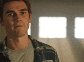 Ad gif. KJ Apa as Archie on Riverdale looks at us raises his eyebrows and turns away quickly to leave as he says, "Fine, whatever..."