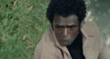 Movie gif. Calvin Lockhart as Frankie in Melinda. He's staring at someone unblinkingly as he punches them, over and over again.