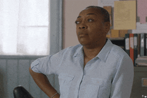 Schitt's Creek gif. Karen Robinson as Ronnie Lee takes her hand off her hip and waves it in front of herself, looking away. She is SO done, with a capital D. 