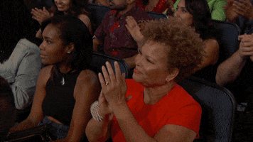 Video gif. Overhead shot of the audience at the BET Awards clapping.