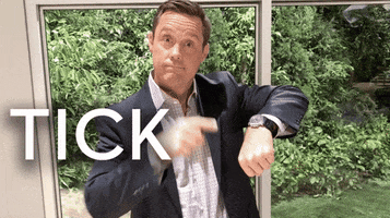 Video gif. A man in a suit jacket points impatiently at his watch. Text, "Tick tock."