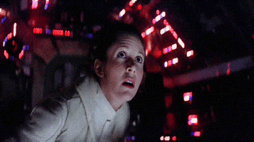Star Wars gif. Carrie Fisher as Princess Leia screams as she recoils back in fear.