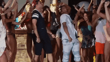 Video gif. A group of attractive young people dance and some throw their hands in the air as they move.  