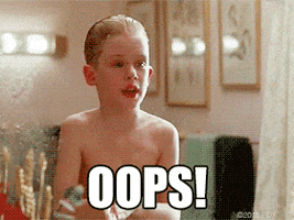 Movie gif. Macaulay Culkin as Kevin McCallister in Home Alone looking in the mirror after bathing, tapping his cheeks, and looking horrified. Text, "oops!"