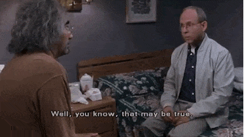 Movie gif. Bob Balaban as Jonathan Steinbloom in A Mighty Wind sitting on the edge of a bed, making a conciliatory gesture and telling someone, "Well, you know, that may be true."
