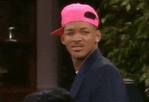 TV gif. Will Smith on the Fresh Prince of Bel Air, wearing a sideways pink baseball cap, sneers and squints over his shoulder, giving a side-eye.