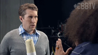TV gif. Scott Aukerman and Reggie Watts from Comedy Bang Bang turn to face us excitedly and shout, "Awesome!” with Reggie giving a thumbs up.
