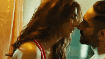 Movie gif. Vaani Kapoor as Maanvi pulls Ayushmann Khurrana as Manu toward her for a passionate kiss in Chandigarh Kare Aashiqui.