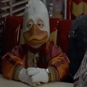 Movie gif. Howard the Duck nods slowly while resting his clasped hands on a desk and tapping his fingers.