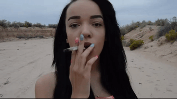 Pretty Cannabis Smoker In The Desert GIF