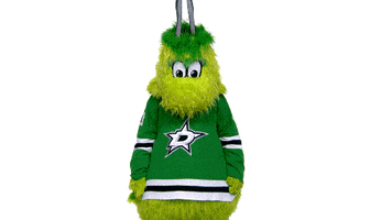Video gif. Victor E Green, the Dallas Stars mascot, whips its hips around, bouncing its butt, as it turns in a circle, finishing with a wave and blowing a kiss.