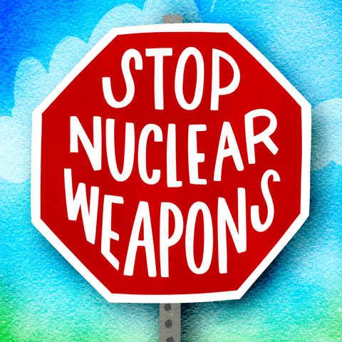 Digital art gif. Cartoon red stop sign with bold, all-caps letters inside that read, "Stop nuclear weapons," against a sunny blue sky background.