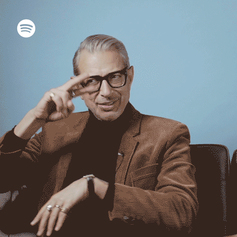 Celebrity gif. Jeff Goldblum dances as he sits, moving his hands around in classic 1960s dance moves, and shimmying his chest as he licks his lips like he’s trying to be seductive.