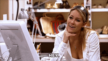 Reality TV gif. Lauren Conrad in The Hills smiles as she rests her chin on the back of her hand. Text, "Hey."