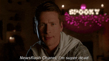 TV gif. Glen Powell as Chad in Scream Queens sits in a dimly lit room and furrows his brow as he says, "Newsflash Chanel, I'm super dead."