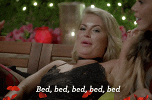 Reality TV gif. A contestant from The Bachelor Australia leans on an outdoor couch and says, "Bed, bed, bed, bed, bed," while widening her eyes excitedly.