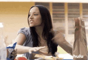 TV gif. Tracy Perez as Vanessa and Gabriel Chavarria as Jacob in East Los High. Vanessa shoots up from the table and tries to fight someone but Gabriel grabs her arms and holds her back.