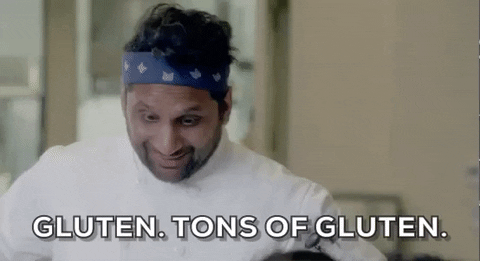 a cook wearing blue headband saying "Gluten. Tons of Gluten"