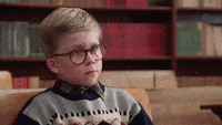 Movie gif. Peter Billingsley as Ralphie from A Christmas Story puts his head down on top of his arms at his school desk, dejected.