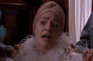 TV gif. Scene from Are you Afraid of the Dark. Younger woman in 1920s clothes has a shocked expression on her face and slowly her face ages into a very old woman.