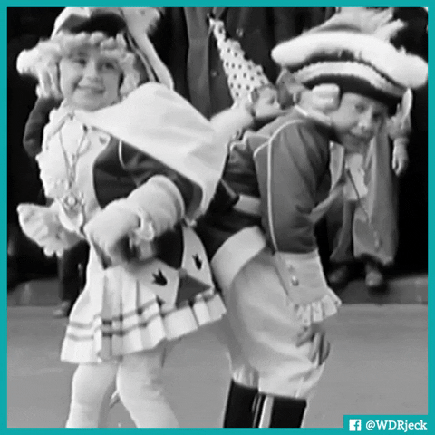 Video gif. Black and white gif of 2 boys in elaborate colonial costumes dancing with their backsides together. They lean forward as they sway side to side.