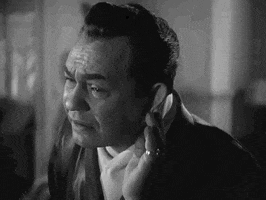 Movie gif. Edward G. Robinson in Johnny Rocco. He puts a hand to his ear to listen closely and he makes an expression and sound of understanding before leaning back and nodding.