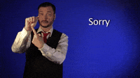 Video gif. A clip from Sign with Robert, showing how to say "sorry" in American Sign Language. He holds up his hand in a fist and points to his palm, then brings the fist to the center of his chest and makes a tight circle with it.