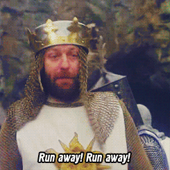 Movie gif. Monty Python and The Holy Grail, King Arthur in a closeup says, "Run away! Run Away!" And then we see him and his knights run away from the mouth of a cave, one of them dropping his shield in his haste.