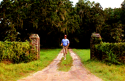 Movie gif A determined Tom Hanks as Forrest Gump runs out of his familys property onto the road
