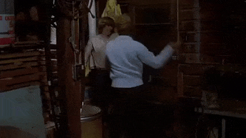 Movie gif. Clip from Friday the 13th, where Betsy Palmer as Mrs Voorhees repeatedly slaps and shoves Alice Hardy, played by Adrienne King.