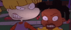 Cartoon gif. Angelica and Susie from Rugrats get up close to us and snarl menacingly with their eyes wide and teeth bared.