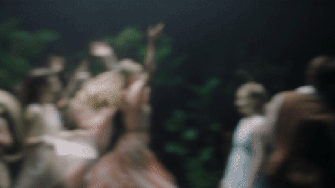 Gif of girls dressed as fairies dancing in the woods