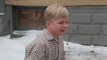 Movie gif. A sad Peter Billingsley as Ralphie from a Christmas Story sits in the snow and sobs.