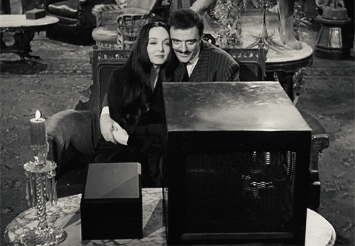 Gif from the Addams Family of them watching TV