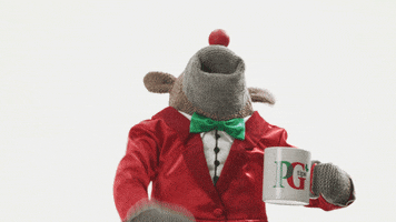 Video gif. The PG Tips monkey puppet holds a mug and laughs with its head tossed back before falling over.