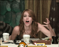 Celebrity gif. Marisha Ray on Critical Role leans on the table with her mouth open in shock. She looks around and waves her arms around, still not believing what she had just witnessed.